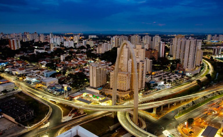 Vista aérea noturna destaca infraestrutura urbana moderna e potencial de investir em São José dos Campos.